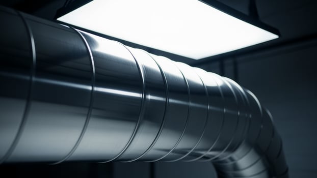 A close up of a metal pipe in a dark room photo
