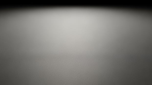 A black and white photo of a light shining on a surface