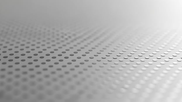 A close up of a metal surface with dots photo