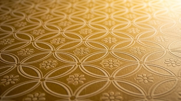 A close up of a gold wallpaper with a pattern photo