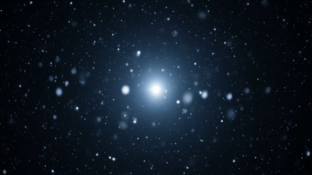 A bright star in the night sky with snow falling photo