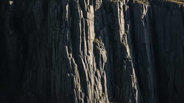 A mountain with a tall rock wall photo