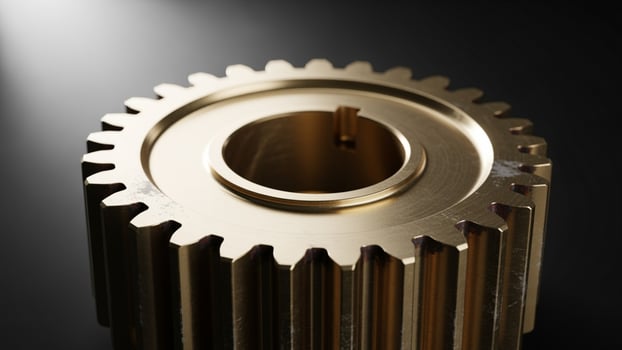 A golden gear on a black surface photo