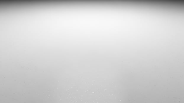 A black and white photo of a person walking in the dark