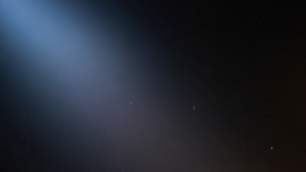 A bright light shining through the dark sky photo