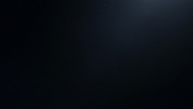 A black sky with a bright light shining through it photo