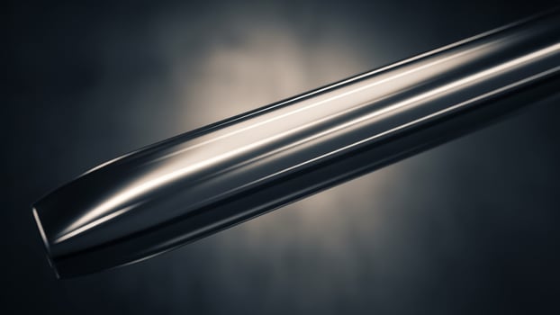 A close up of a metal object on a dark background photo