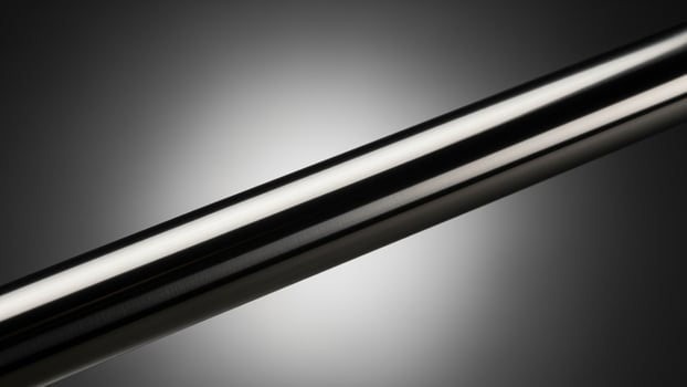 A close up of a metal tube on a black background photo
