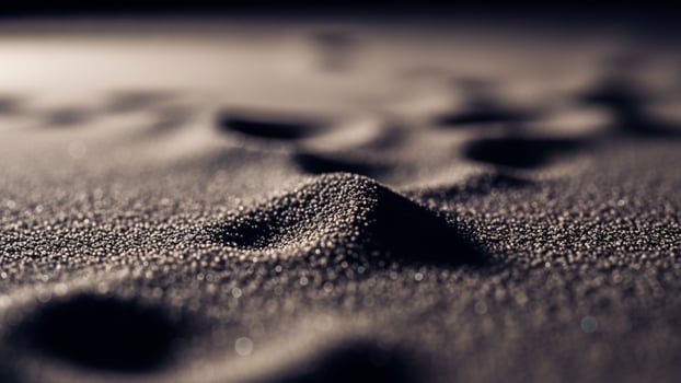 A close up of sand with footprints photo