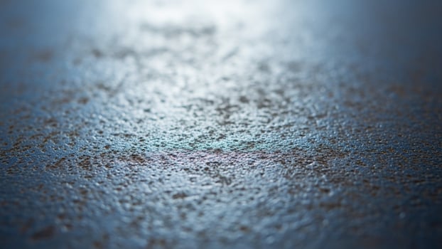 A close up of a shiny surface with some water on it photo