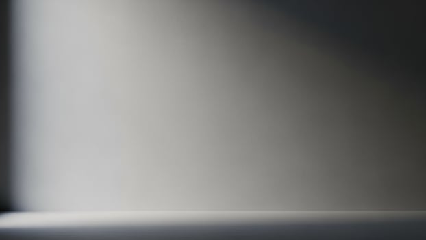 A black and white photo of a wall with light coming in