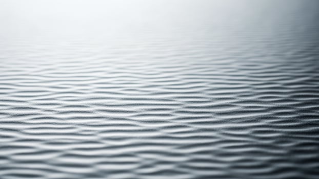 A close up of a wavy surface with a light background photo