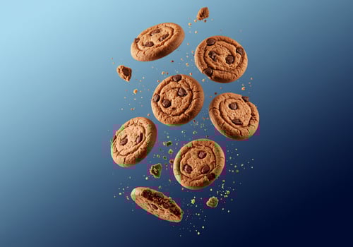 Chocolate Chip Cookies Floating Against a Blue Background for Food Product photo