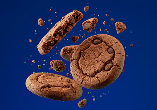Chocolate cookies fall, crumbs fly on a deep blue background. Sweet, dessert photo