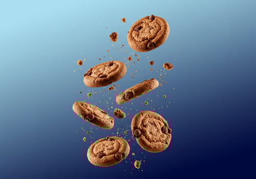 Cookies with chocolate chips in air with crumbs falling down, food product photo