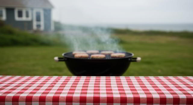 Grilling patties on the lawn near the shore for a backyard bbq party photo