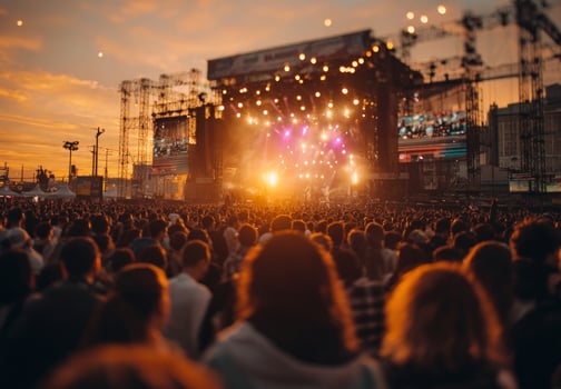 Crowd enjoying live music at outdoor festival during sunset photo