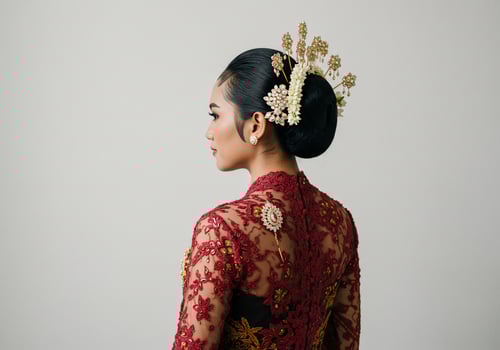 Javanese woman wearing traditional Kebaya for wedding reception, white background photo