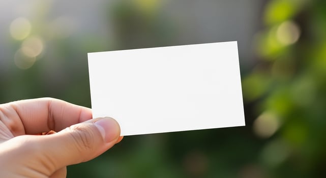 A person holding a blank piece of paper in their hand photo