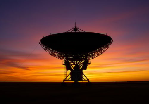 Radio telescope silhouette against sunset, space exploration, astronomical observatory photo