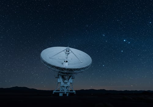 Radio telescope searches cosmos at night observing stars from remote desert location photo