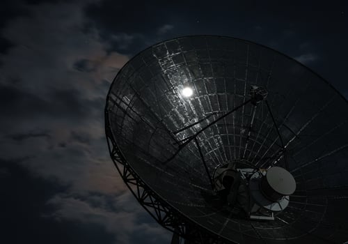 Satellite dish transmits at night with clouds, moon. Astronomy use photo