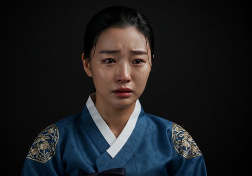 Woman in traditional dress crying with tears, isolated on a dark background photo