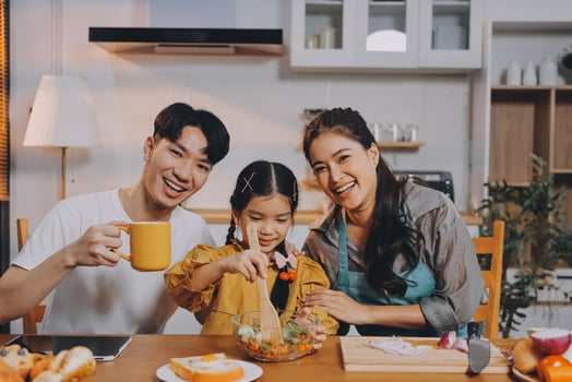Asian family enjoying meal together in kitchen photo