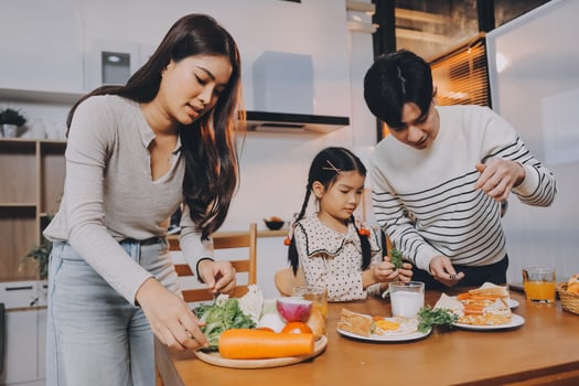 Asian family preparing healthy meal at home photo