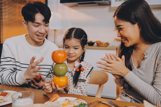 A family eating together at the table photo