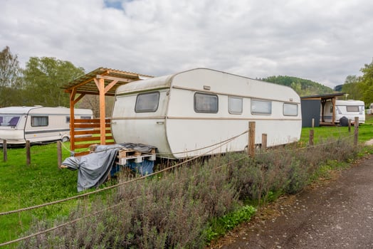 Vintage travel trailer in green campsite near Slapy lake in Czech Republic in spring photo