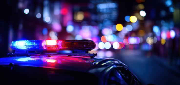 The police car with flashing lights in a vibrant urban environment at night. photo