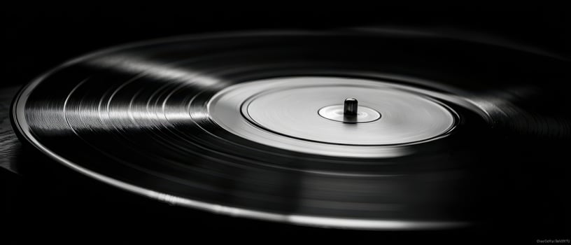 The elegant vinyl record spinning on a turntable in black and white. photo