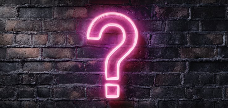 The Neon Question Mark Illuminates a Brick Wall in a Modern Setting photo