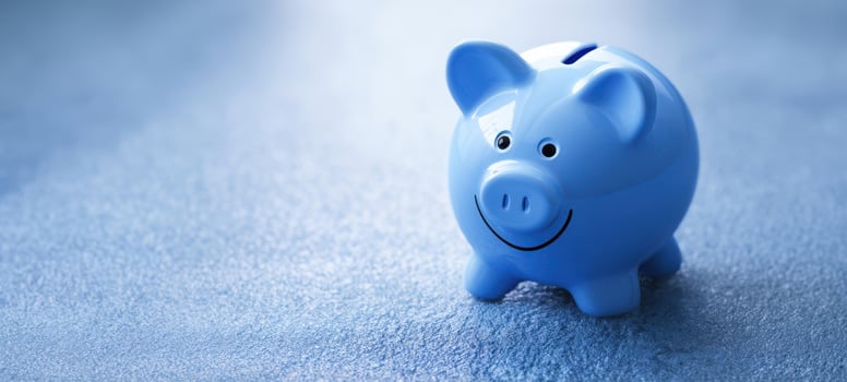 The adorable blue piggy bank smiling on a textured surface. photo