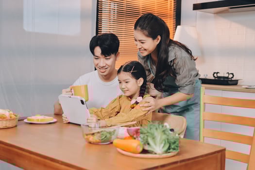 Asian family using tablet to cook together photo