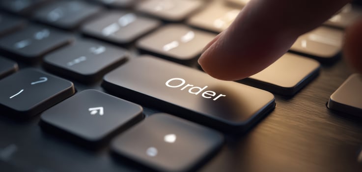 The close-up view of a finger pressing the order button on a keyboard. photo