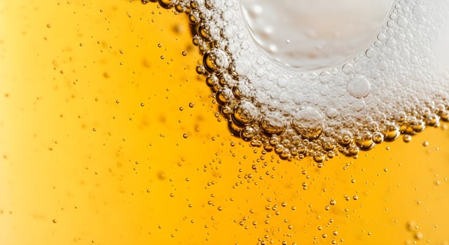 Close up of dark beer in a glass, showcasing effervescent bubbles and creamy foam. A versatile template for Oktoberfest, Beer Day, or fresh drink ads ample space for your text. photo