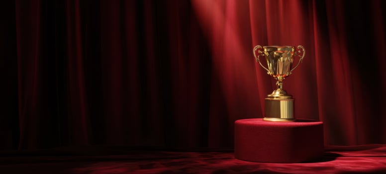 The golden trophy shining on a pedestal under a spotlight backdrop. photo