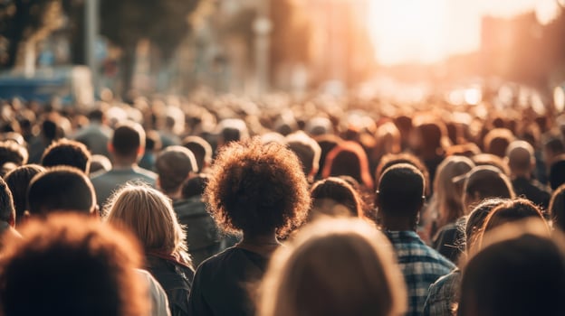The vibrant crowd united at sunset during a large public gathering. photo