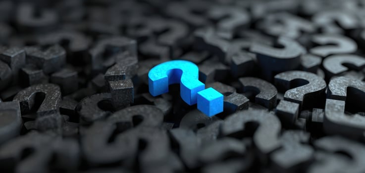 The Blue Question Mark Standing Out in a Sea of Black Symbols photo