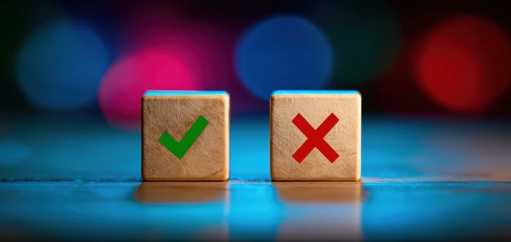 The wooden cubes representing approval and disapproval against a colorful background. photo