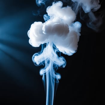 Wispy blue smoke swirling upwards against dark background photo