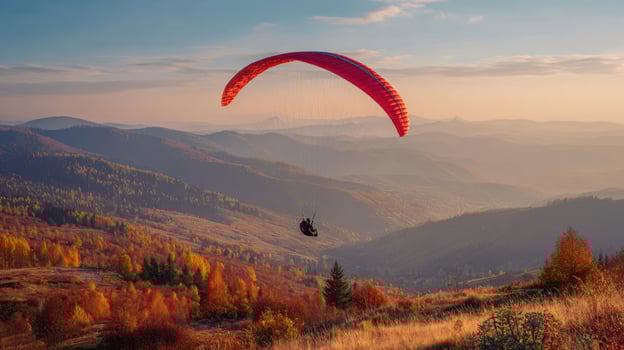 The breathtaking experience of paragliding over autumn landscapes at sunset. photo