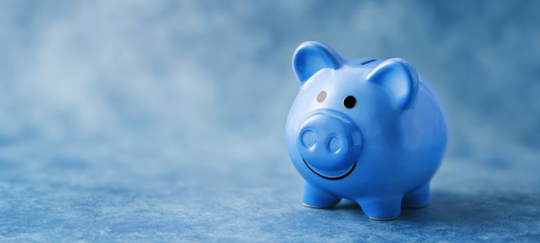 The cheerful blue piggy bank on a soft textured background. photo