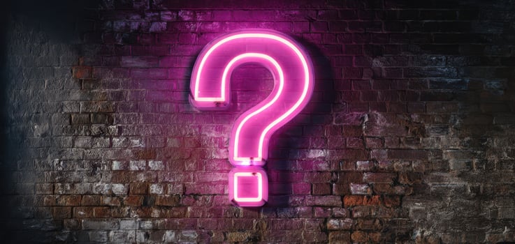 The Neon Question Mark Illuminating an Urban Brick Wall Design photo
