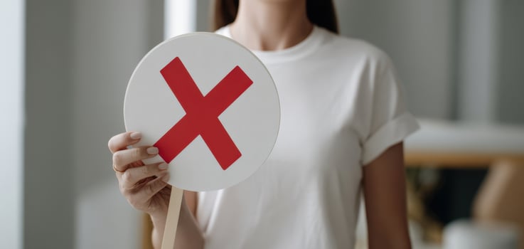 The Woman Holding a Round Sign with a Red Cross for Rejection photo
