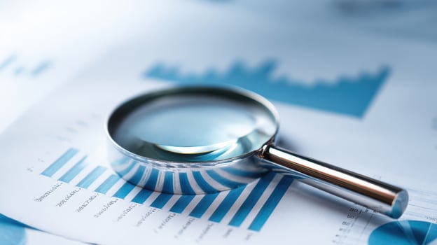 The magnifying glass on business statistics for detailed analysis and insights. photo