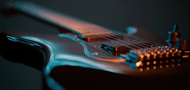 The electric guitar showcasing intricate details and stunning craftsmanship in a soft glow. photo