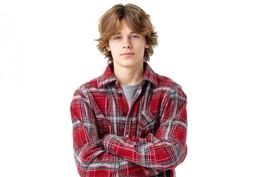 Teen in plaid shirt with arms crossed portrait on white background photo